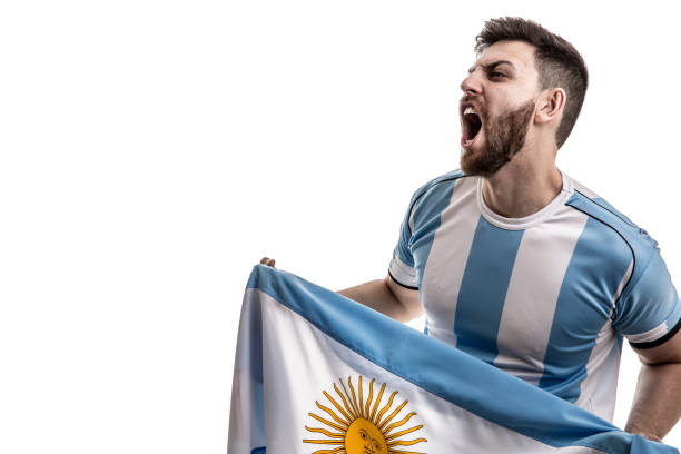 istock Argentinian male athlete / fan celebrating on white background 908080558