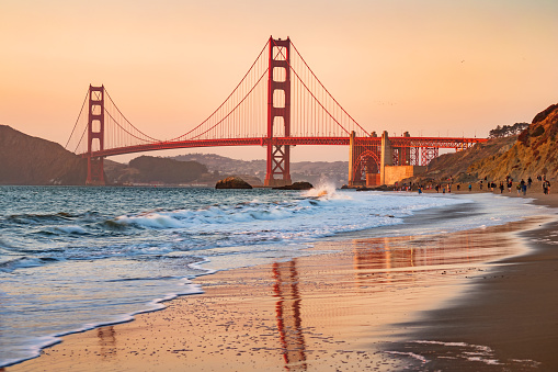 Stock photograph of Marshall's Beach and the landmark Golden Gate Bridge in San Francisco California USA during sunset gold hour.