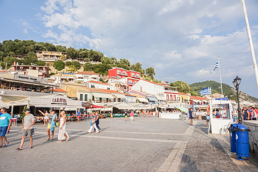 PARGA, GREECE 8. JULY 2016. Small main square and the promenade. Local people and tourists are walking by.