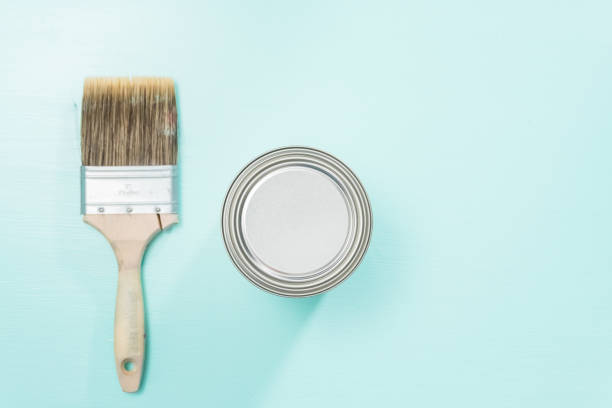 istock Top view of metal paint can and paint brushes on painted surface 908122082