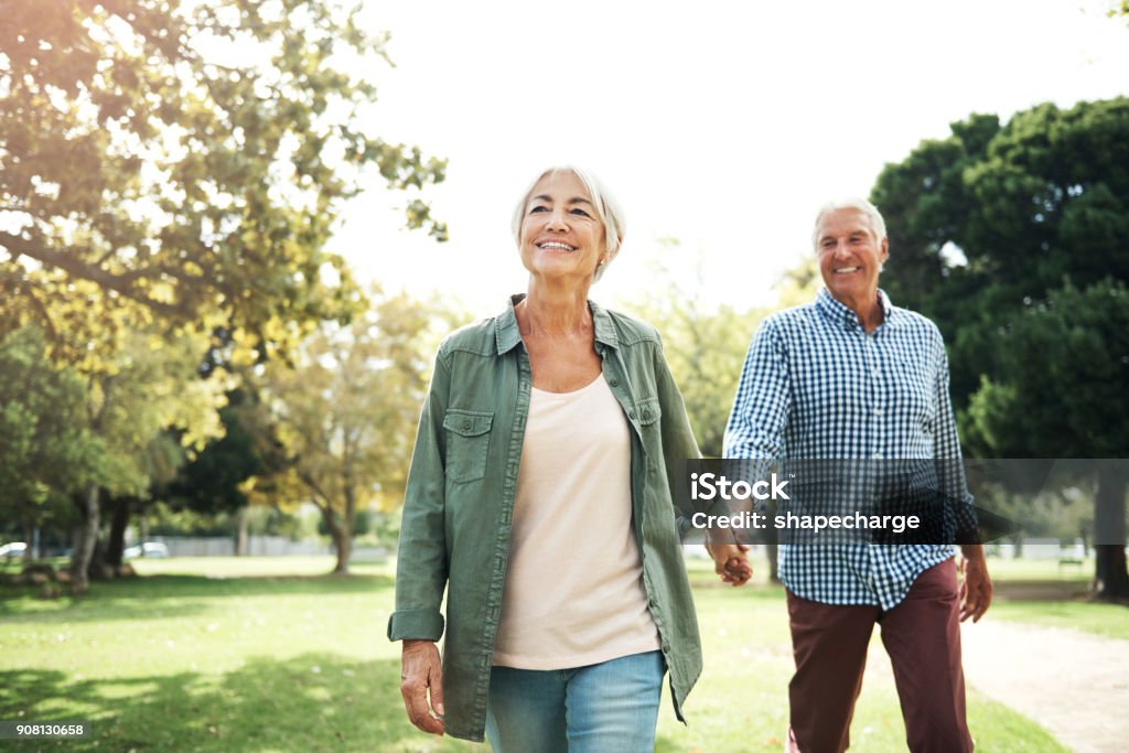 Staying in love is something very special Shot of a happy senior couple going for a walk in the park Walking Stock Photo