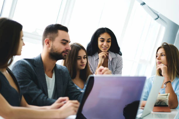 istock Dream team of young students enjoying workshop improving skills and knowledge together, diversity group collaborating on project using technology watching training webinar in coworking space 908130774