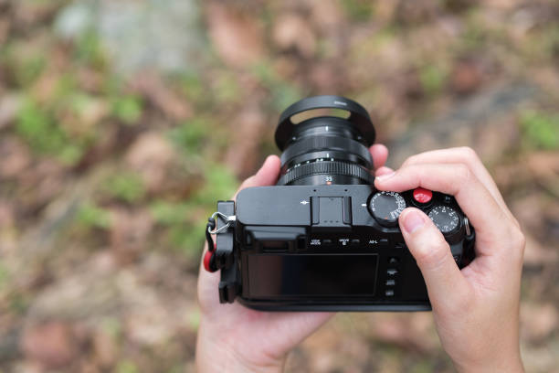 istock Photographer, Camera on hand. Photograph hobby 908147458