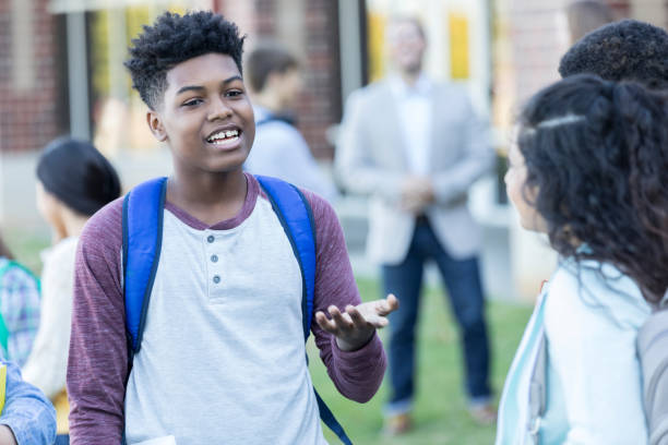 istock Teenage boy asks girl on date between classes 908148086