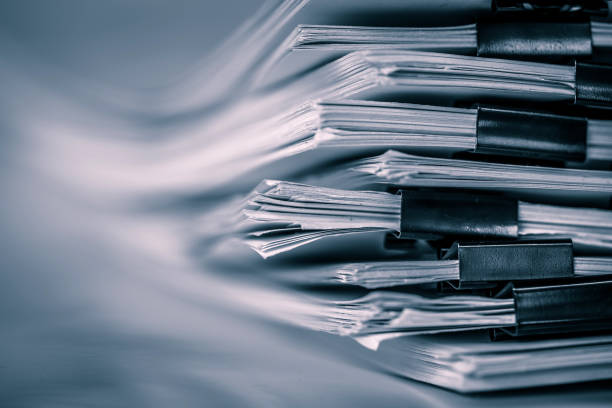 the extreamely close up  report paper stacking of office working document , retro color tone stock photo