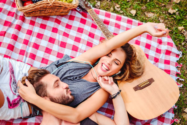 istock couple cuddling on a picnic blanket 908163024