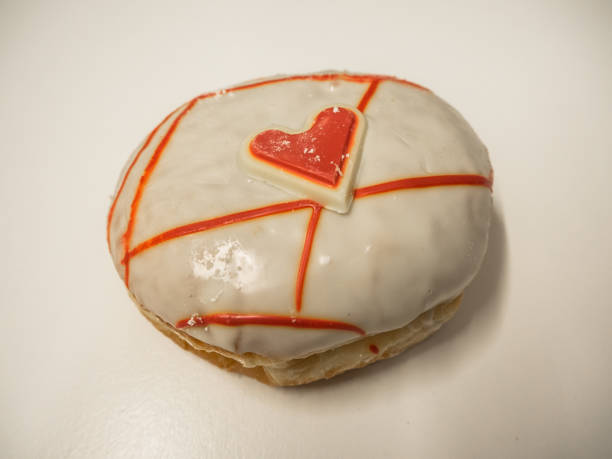 istock Krapfen with sugar glaze and red chocolate heart 908165536