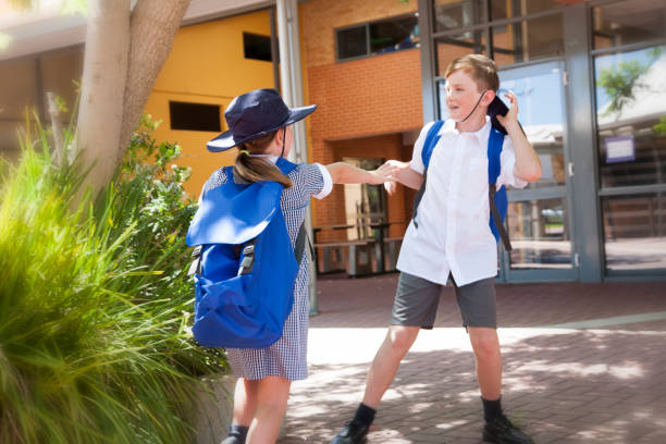 School Days Two schoolchildren playing and rough housing in the schoolyard, Australia schoolyard fight stock pictures, royalty-free photos & images