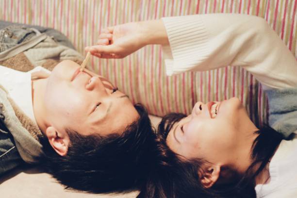 istock Young couple lying on the sofa 908168322