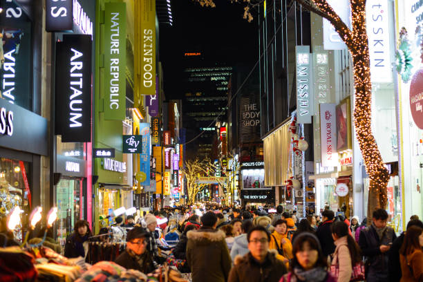 Seoul, South Korea - December 16, 2015 : Crowds enjoy the Myeong-Dong district nightlife in Seoul Seoul, South Korea - December 16, 2015 : Crowds enjoy the Myeong-Dong district nightlife in Seoul. dong stock pictures, royalty-free photos & images