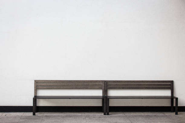 istock White wall and modern wooden bench. 908174974