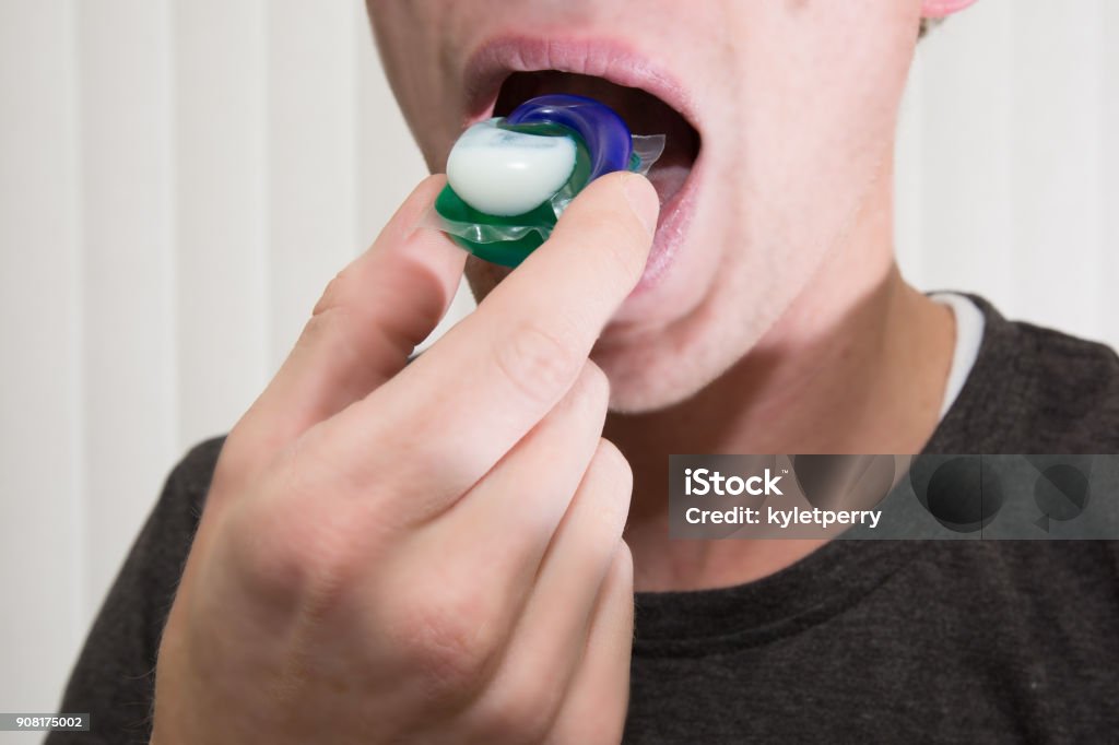 Eating Laundry Pods It is ill advised to eat laundry pods yet it is a current viral fad with the young generation. Poisonous Stock Photo