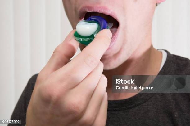 Eating Laundry Pods Stock Photo - Download Image Now - Poisonous, Teenager, Careless