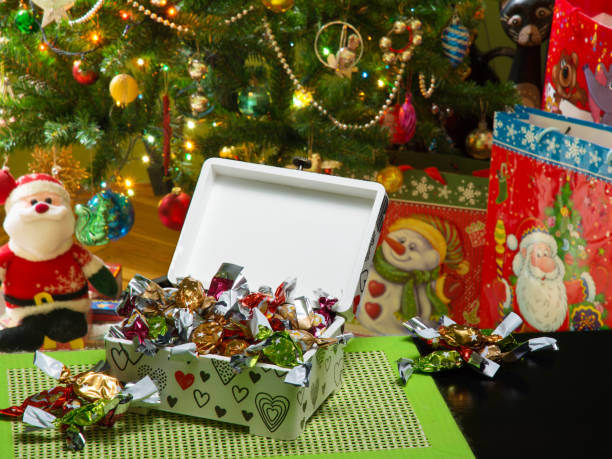 istock Decoupage box, parlour candies. Christmas tree, gift bags. Blurry background. 908178260