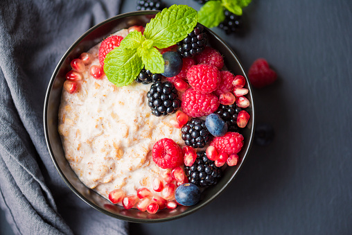 Organic Chia and Quinoa Porridge with soya yoghurt, millet, mint leaves, rasbperries, blackberries, blue berries and pomegranate seeds