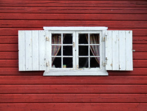 White window in a old red wooden wall