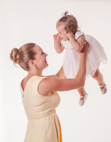 Happy mother with her daughter studio shoot over white background.