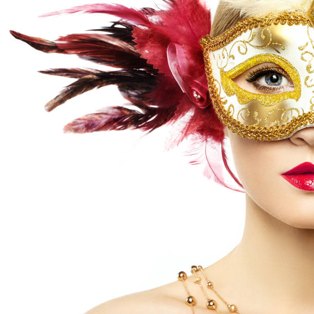 Beautiful young woman in mysterious golden Venetian mask Beautiful young Woman in Mysterious Golden Venetian Mask. Fashion photo. Masquerade Mask with Red Feathers carnival mask women party stock pictures, royalty-free photos & images