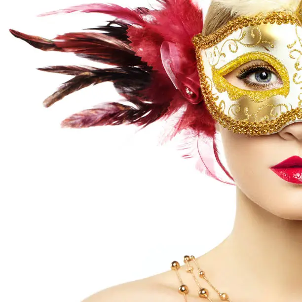 Photo of Beautiful young woman in mysterious golden Venetian mask