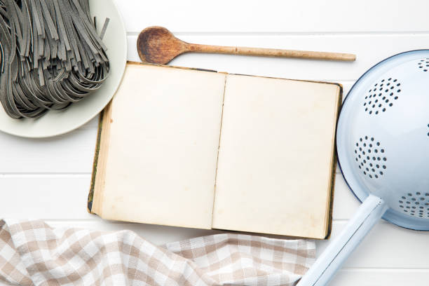 istock cookbook and black noodles with squid sepia ink on white table 908201454