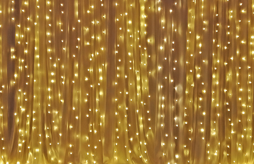 Yellow drape with many light bulb as background