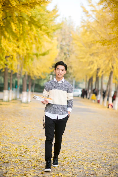 istock male Student Walking Across Campus 908207822