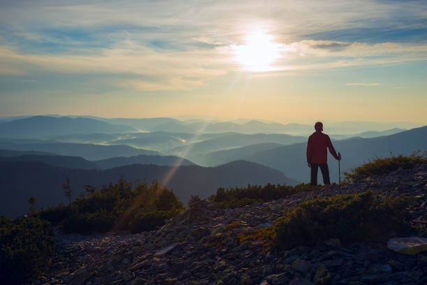 istock Man traveler stands on a stony mountain range 908210558