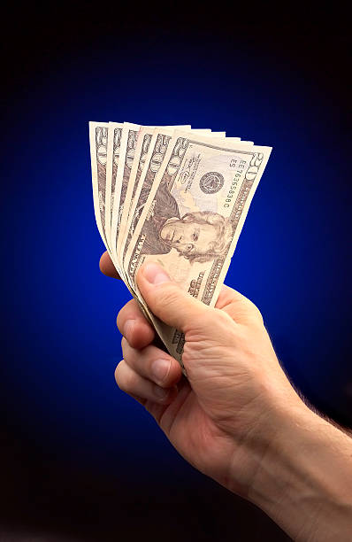 Holding Money stock photo