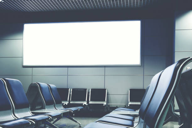 istock Blank billboard with clean space for publicity content or text message, advertising mock up in interior, public commercial board in waiting of airport hall with empty chairs, template banner indoors 908213698