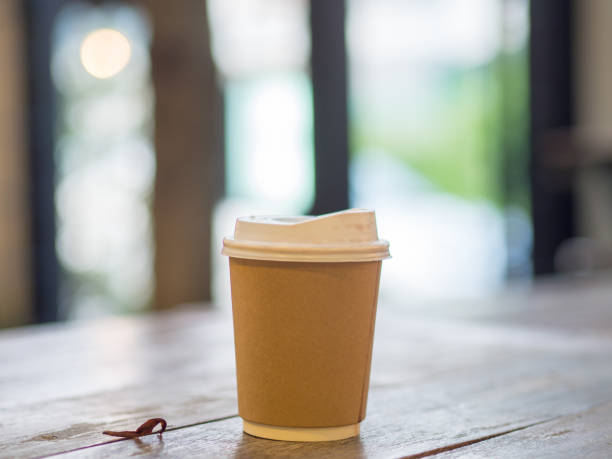 istock Paper cup of hot coffee in the cafe. 908214026