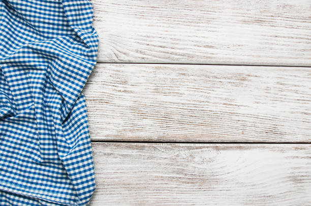 istock Checkered napkin on a wooden background 908214362