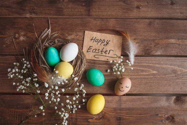 istock Green and yellow Easter eggs on rustic wooden background . Easter greeting card 908219076