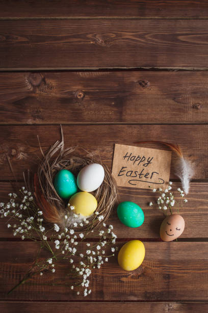 istock Green and yellow Easter eggs on rustic wooden background . Easter greeting card 908219350
