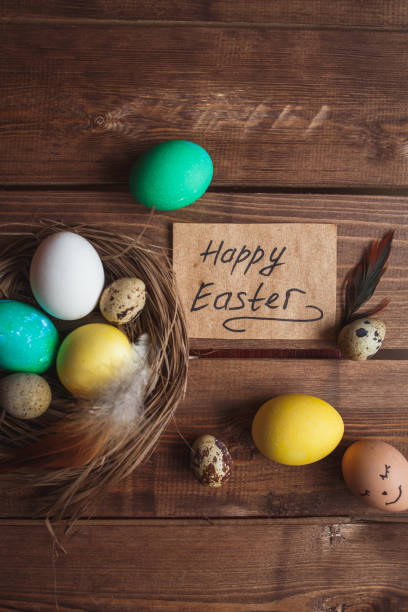 istock Green and yellow Easter eggs on rustic wooden background . Easter greeting card 908219486