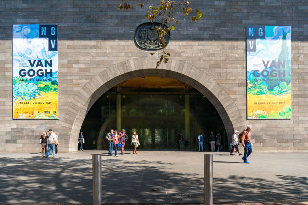 National Gallery of Victoria entrance with advertisement banners of Van Gogh exhibition Melbourne, Australia - April 18, 2017: National Gallery of Victoria entrance with colorful advertisement banners of Van Gogh exhibition and people casually walking vincent van gogh painter stock pictures, royalty-free photos & images