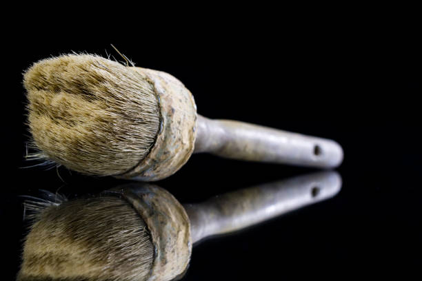 istock A paintbrush for a painter on a glass table. Painting accessories in a mirror reflection. Black background. 908219634