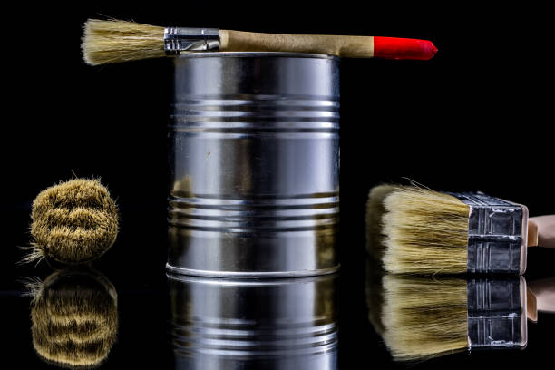 istock A paintbrush for a painter on a glass table. Painting accessories in a mirror reflection. Black background. 908222520