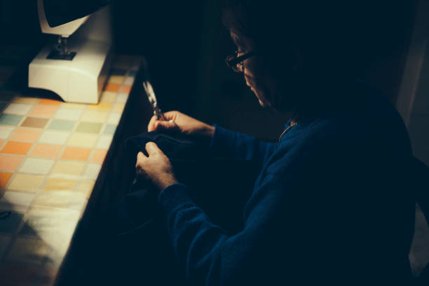 istock Senior woman sewing 908224028