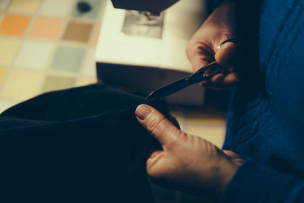 istock Senior woman sewing 908224116