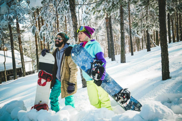 istock Two snowboarders on winter vacation 908224496