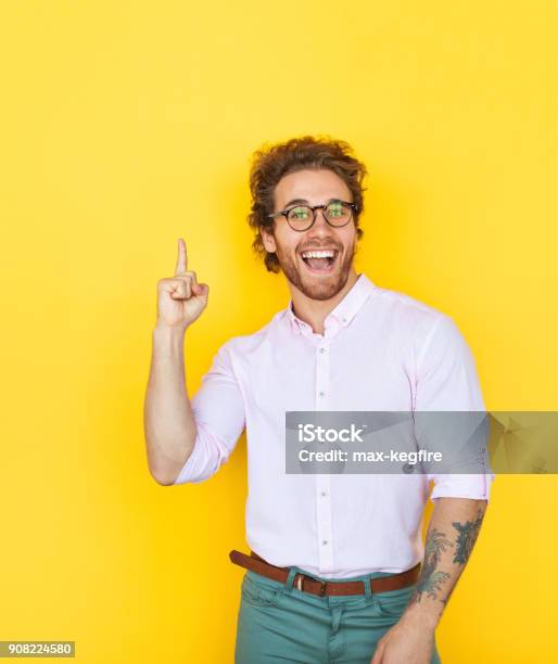Young Stylish Man Pointing Up Stock Photo - Download Image Now - Men, Colored Background, Pointing