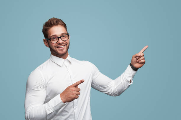 istock Cheerful muscular man pointing on side 908226924
