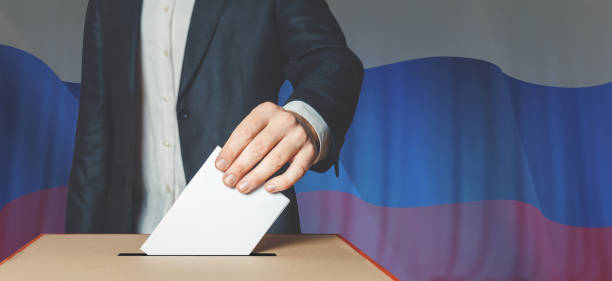 istock Man Voiter Putting Ballot Into Voting box. Democracy Freedom Concept 908228172