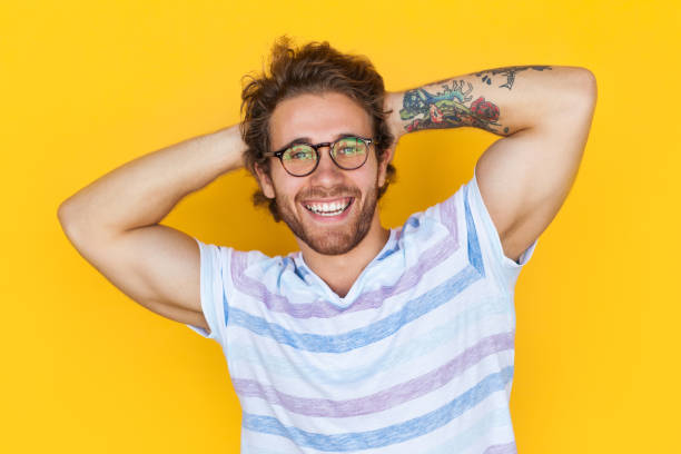 istock Cheerful handsome man with tattooed arm 908228306