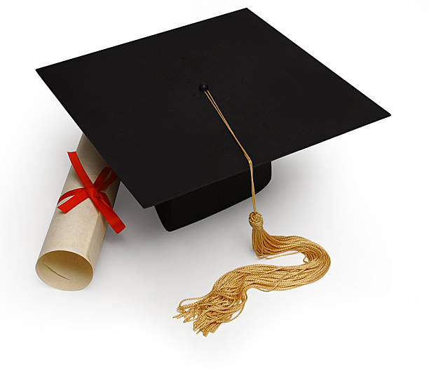 istock Black toga hat and a rolled diploma on a white background 90822872