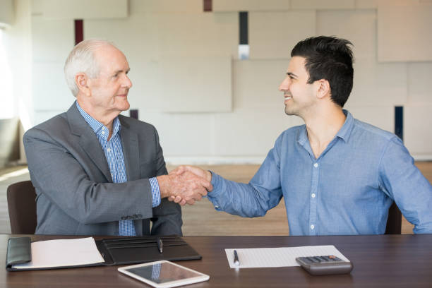 istock Two Positive Businessmen Shaking Hands 908231442