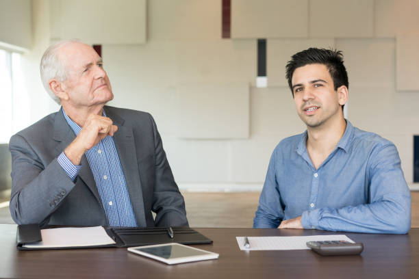 istock Two Serious Business People Discussing Offer 908231454