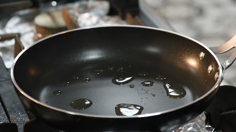 Close up of a chef sauteing vegetables in a pan