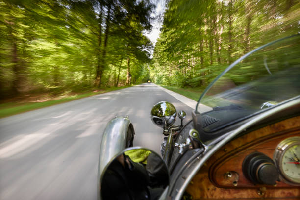 Old vintage open top car on the country road