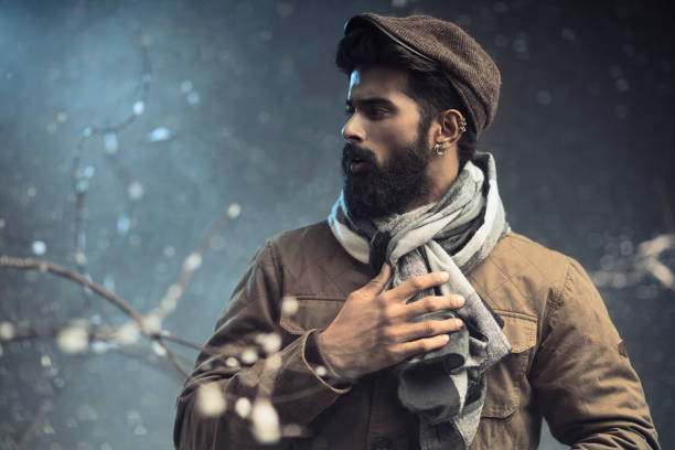 Bearded young man in snow storm, Studio shot.